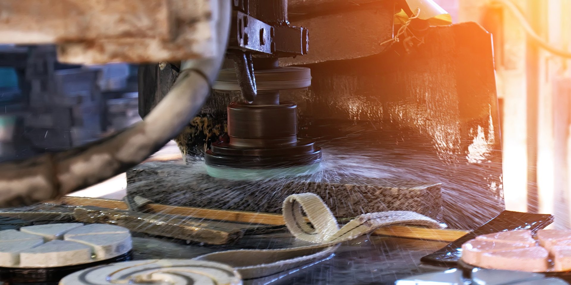 A stone-cutting machine operates in a workshop