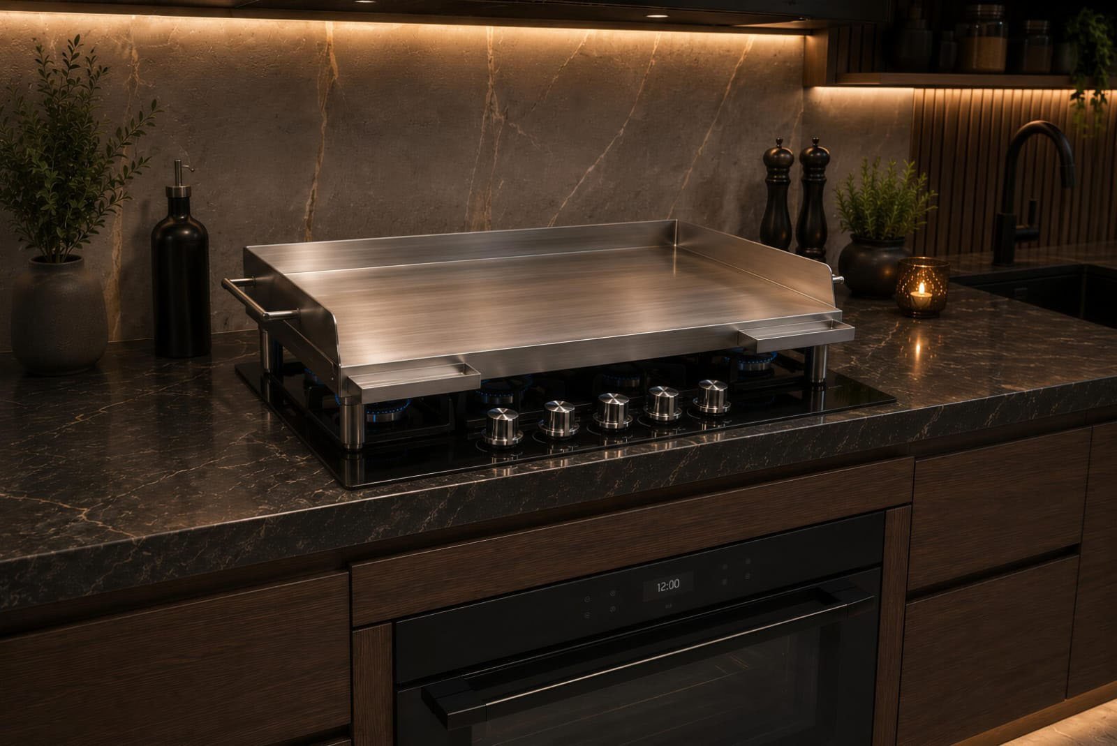 Modern kitchen with stainless steel cooktop on dark marble countertop, ambient lighting, and decorative accessories