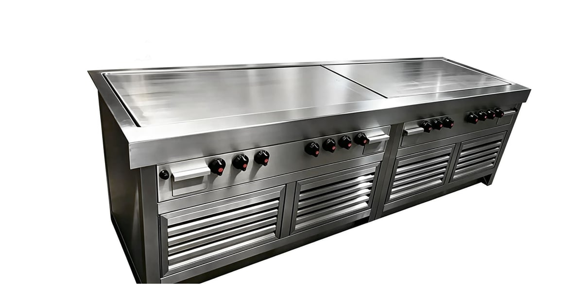 Stainless steel commercial kitchen equipment with cooktop burners, griddle, and refrigerated storage drawers below.